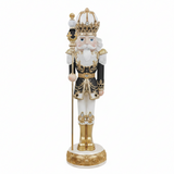 Decorative nutcracker figure with a crown and gold outfit on a white background