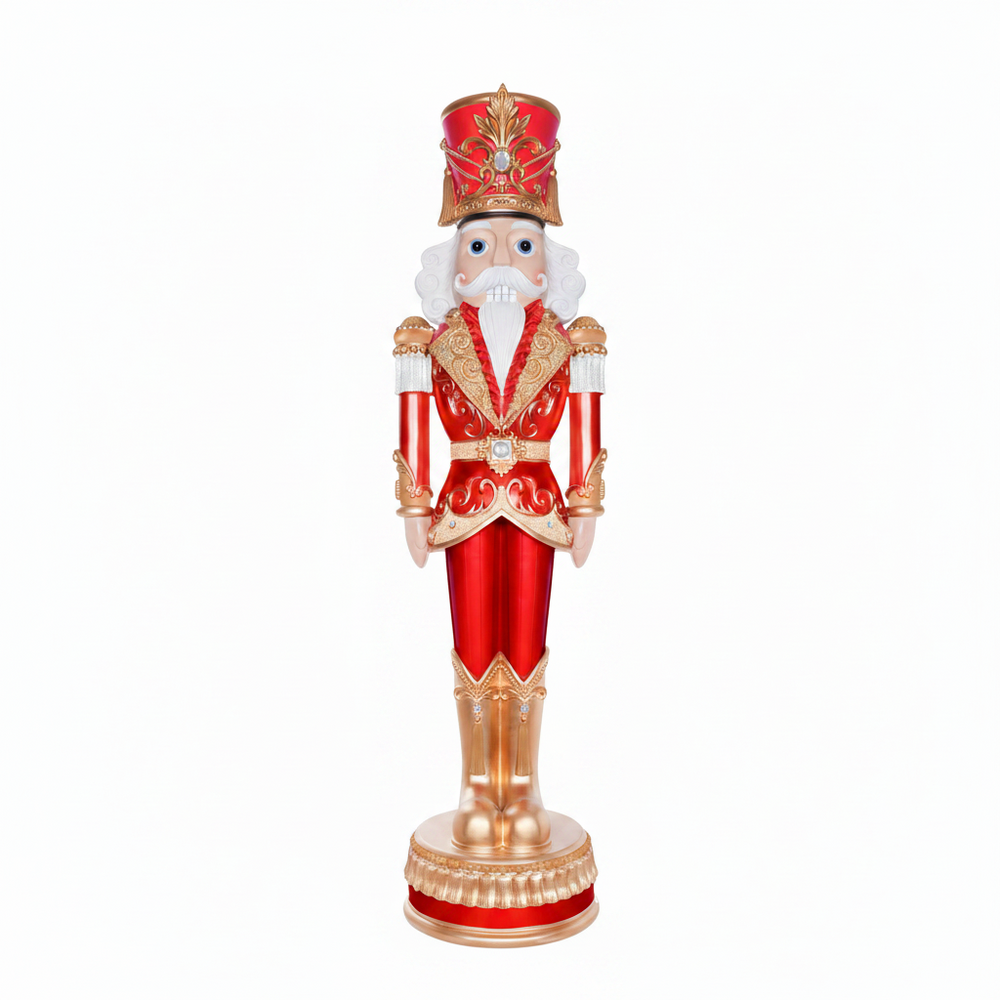 Decorative nutcracker figure in red and gold attire on a white background
