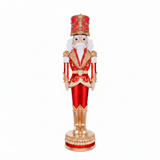 Decorative nutcracker figure in red and gold attire on a white background
