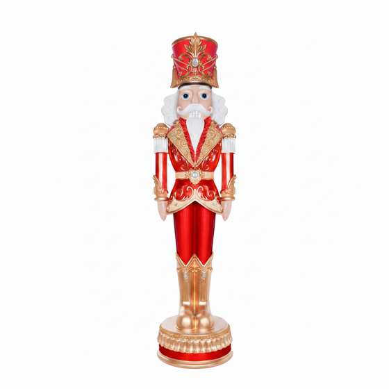 Decorative nutcracker figure in red and gold attire on a white background