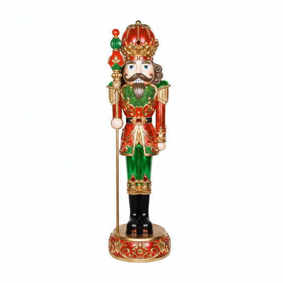 Decorative nutcracker figure with a crown, holding a staff, on a white background