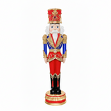 Decorative nutcracker figure with red, blue, and gold colors on a white background