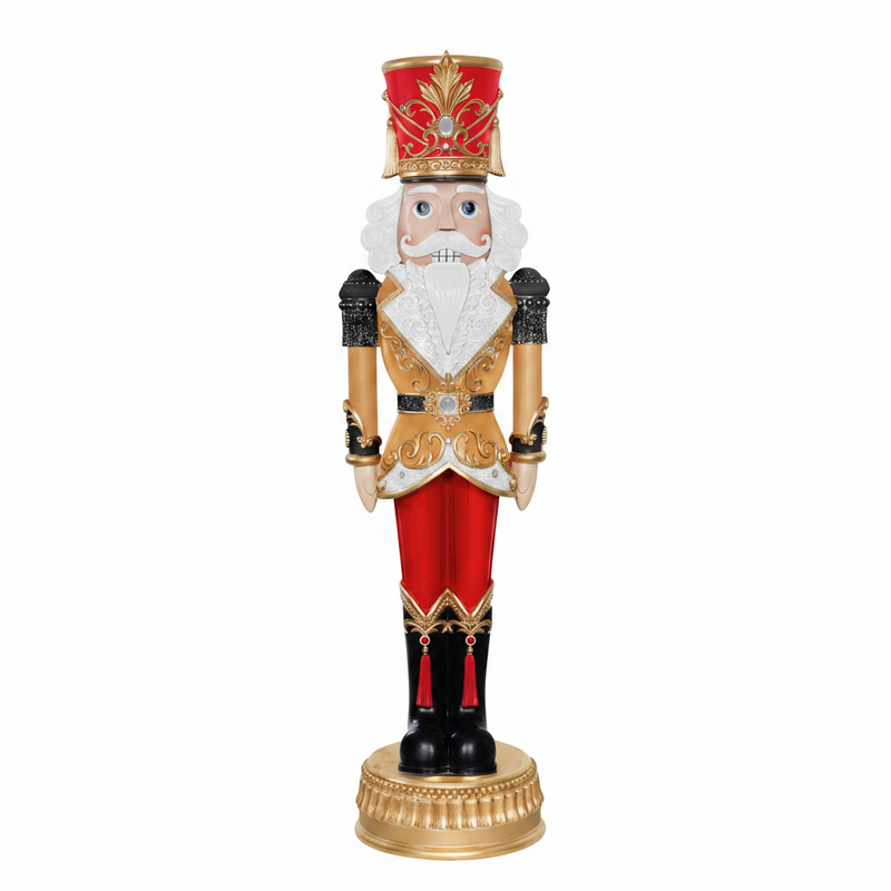 Decorative nutcracker figure with red, gold, and black colors on a white background