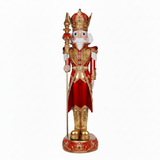 Decorative nutcracker figure with gold and red attire on a white background