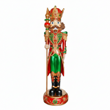 Decorative nutcracker figure with a crown and staff, on a white background