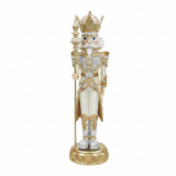Decorative nutcracker figure with a crown and ornate outfit on a white background