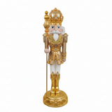 Decorative nutcracker figure with gold and white attire on a white background