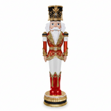 Decorative nutcracker figure with red outfit, white pants, and gold accents on a white background