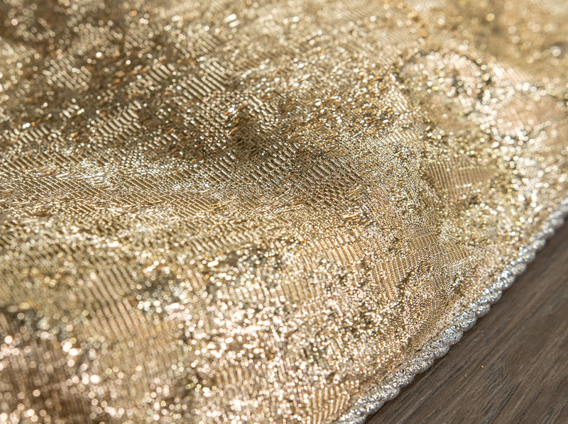 Close-up of a textured gold fabric surface