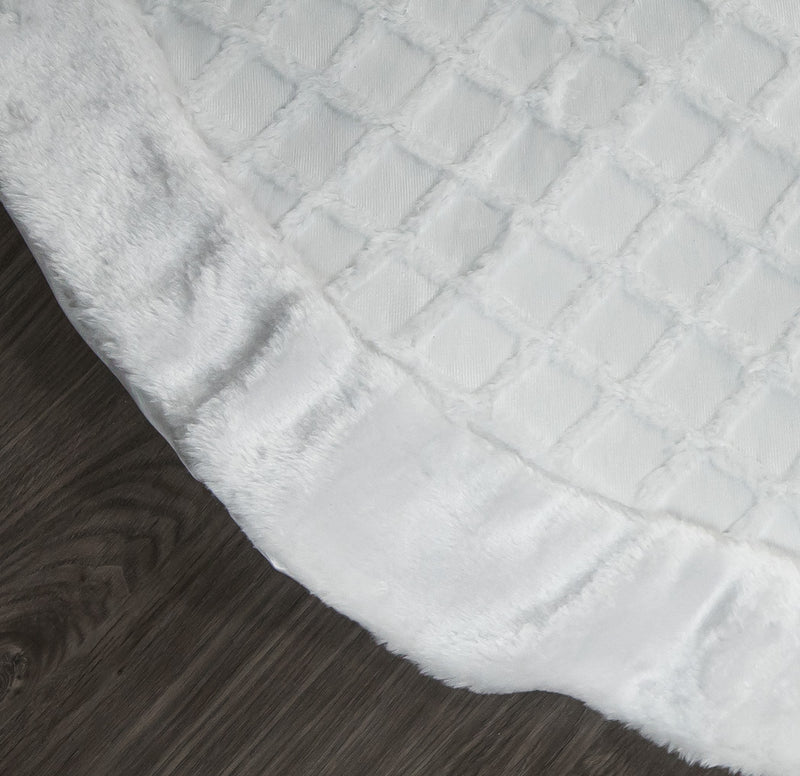 Close-up of a textured white fabric on a wooden surface