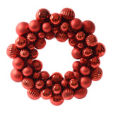 Red decorative wreath made of shiny red balls on a white background