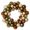 Decorative wreath made of multicolored glass ornaments on a white background