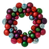 Colorful Christmas ornament wreath with red, green, and purple balls on a white background