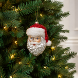 Decorative Santa Claus ornament on a Christmas tree with lights.