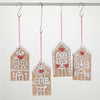 Four gingerbread house-shaped decorations hanging on a rod with a white background.