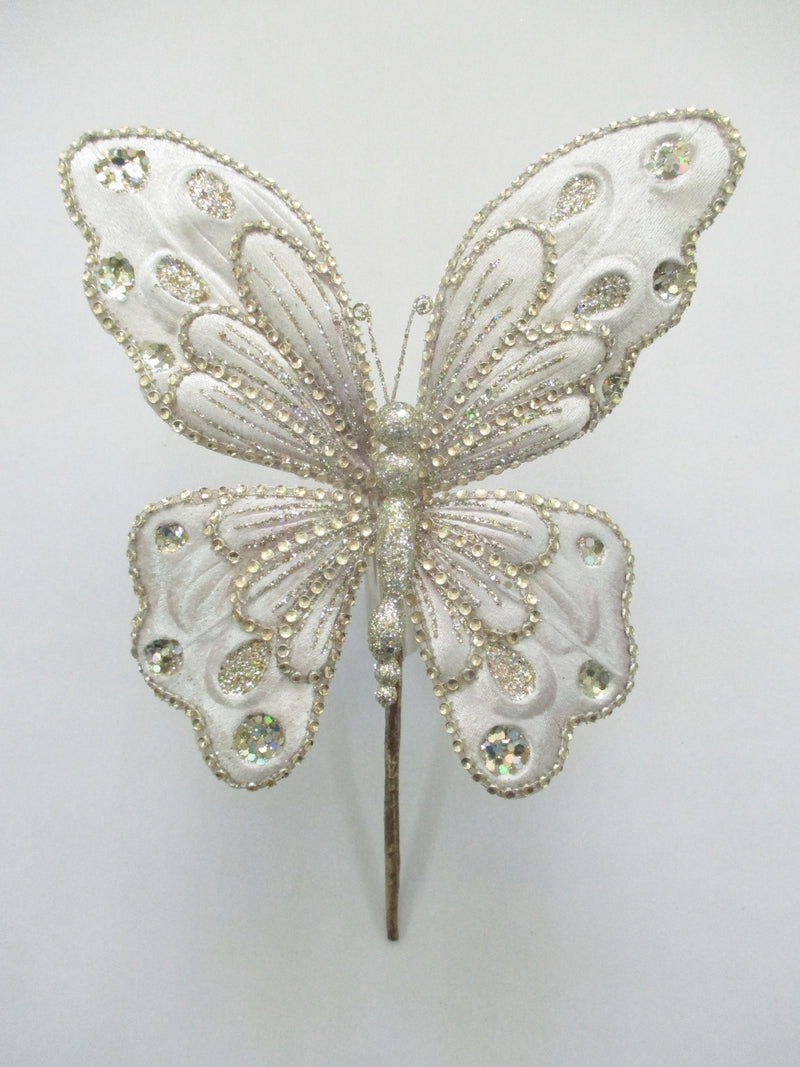 Decorative butterfly pin with intricate design on a white background