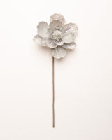 Silver flower-shaped hairpin on a white background