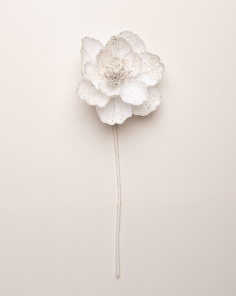 White floral hairpin on a light beige background