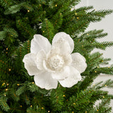 Decorative white flower ornament on a Christmas tree with lights.