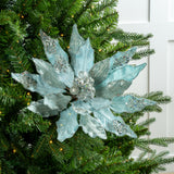 Decorative blue poinsettia on a Christmas tree with green leaves and lights.