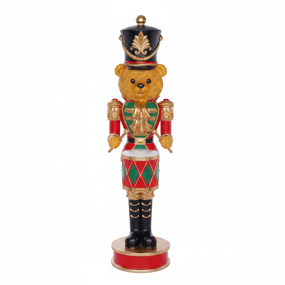 Decorative figurine of a teddy bear in a Nutcracker costume on a white background
