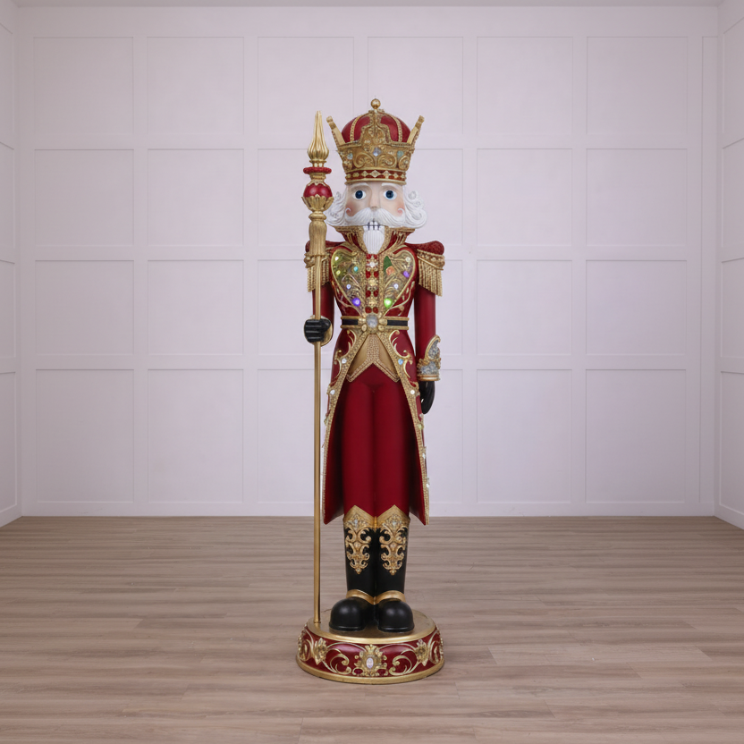 Decorative nutcracker figure with a crown and red robe on a wooden floor.