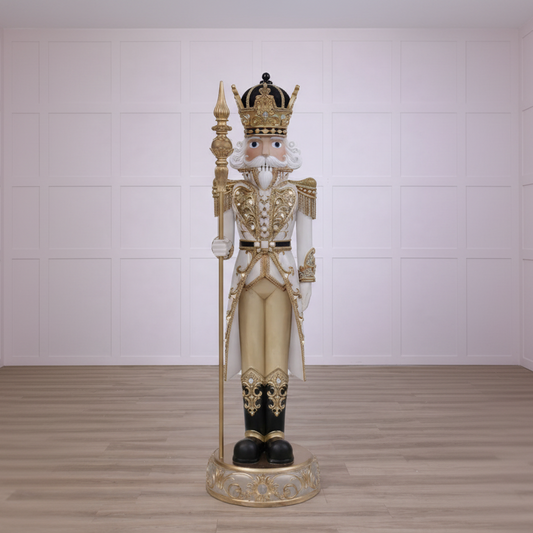 Decorative nutcracker figure with gold and black details on a white background