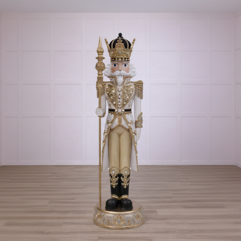 Decorative nutcracker figure with gold and black details on a white background
