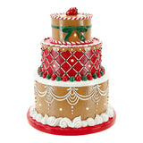 Decorative gingerbread cake figurine with red and white icing on a white background