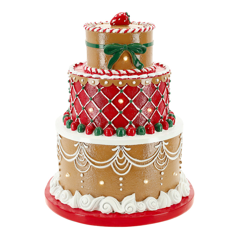 Decorative gingerbread cake figurine with red and white icing on a white background