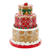 Decorative gingerbread cake figurine with red and white icing on a white background