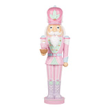 Decorative nutcracker figure in pink and white attire on a white background