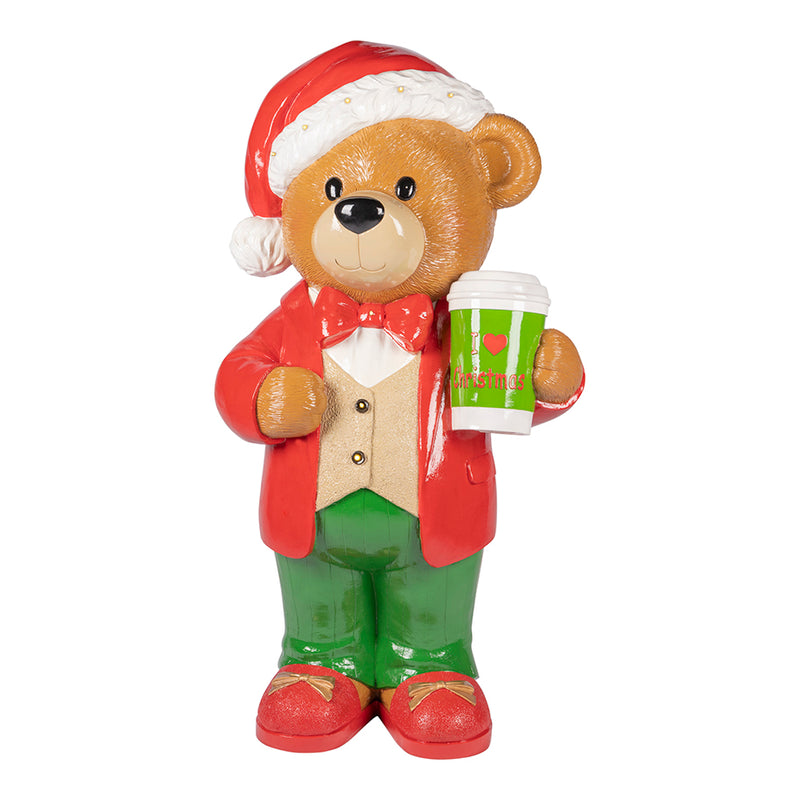 Teddy bear figurine in Christmas attire holding a coffee cup on a white background