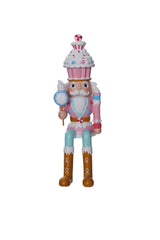 Colorful toy figure of a character with a cupcake on its head against a white background