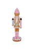 Decorative nutcracker figure with pastel colors on a white background