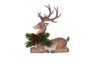 Decorative deer figurine with antlers and greenery on a white background