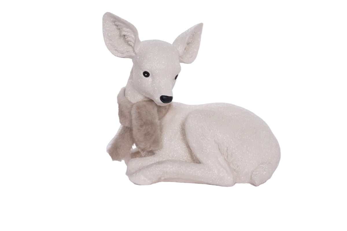 Plush deer toy with a scarf on a light gray background