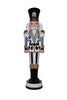 Decorative nutcracker figure with black, white, and gold details on a white background.