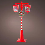 Decorative Christmas street lamp with candy cane design on a gray background