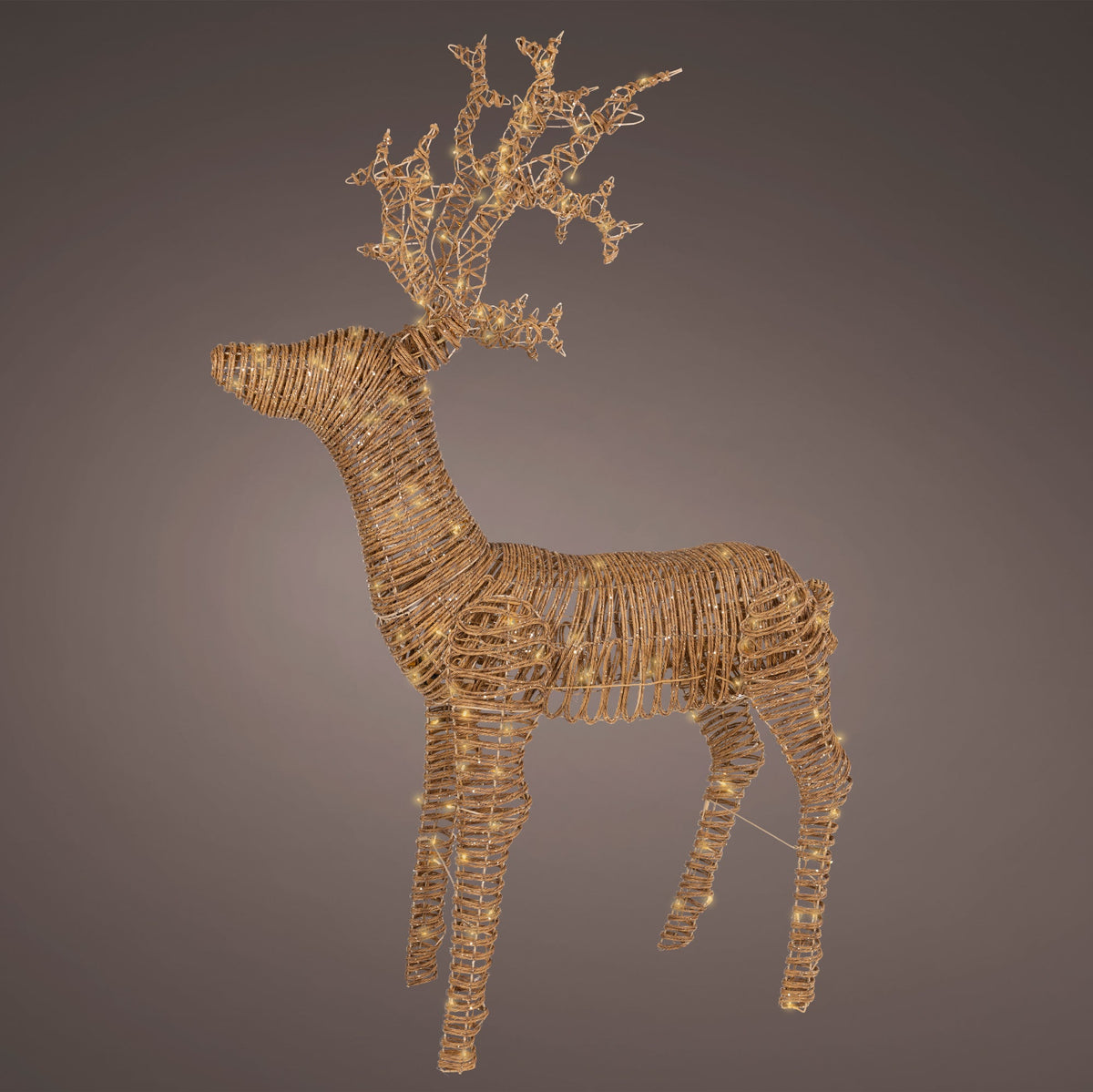 Decorative reindeer made of interwoven materials on a dark background