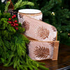 Elegant rose gold ribbon with sparkling botanical accents on a Christmas background