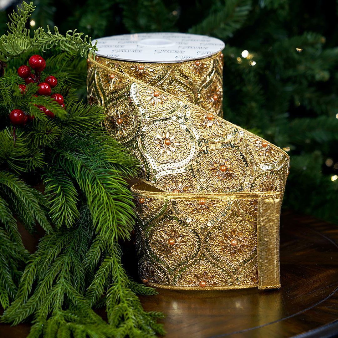 Elegant gold embroidered ribbon with jeweled accents on a Christmas background