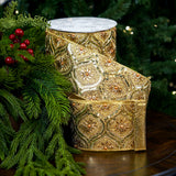 Elegant gold embroidered ribbon with jeweled accents on a Christmas background