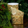 Elegant gold embroidered ribbon with jeweled accents on a Christmas background