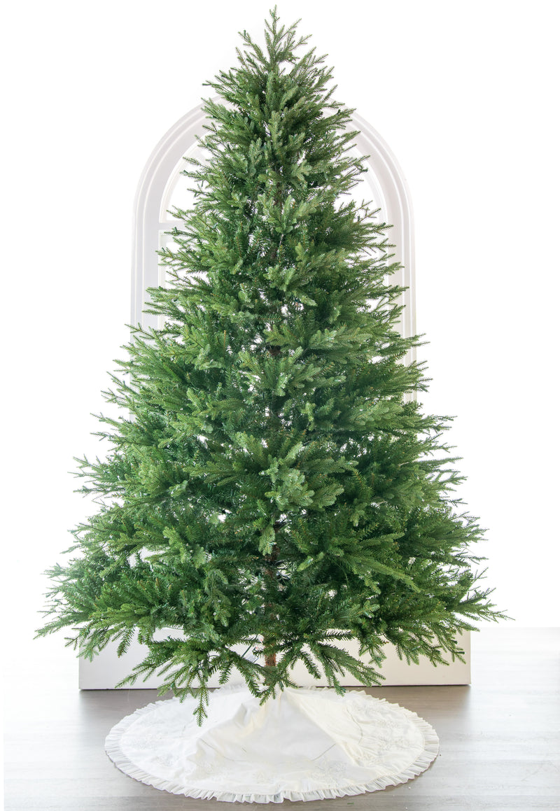 Decorative Christmas tree with a white base on a white background