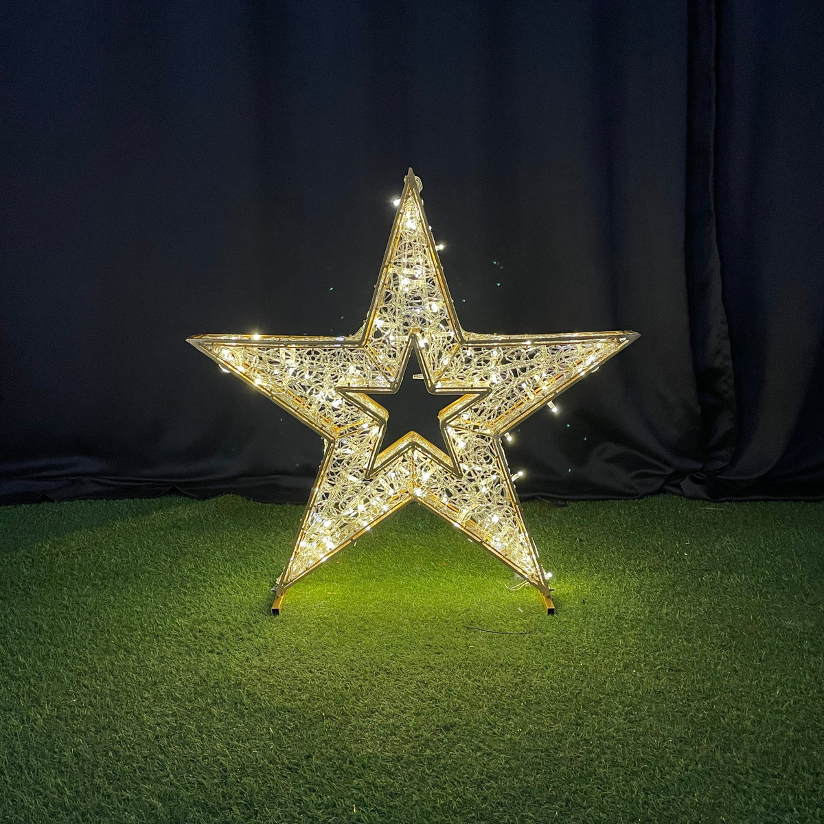Decorative star with rhinestones on a black and green textured surface