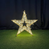 Decorative star with rhinestones on a black and green textured surface