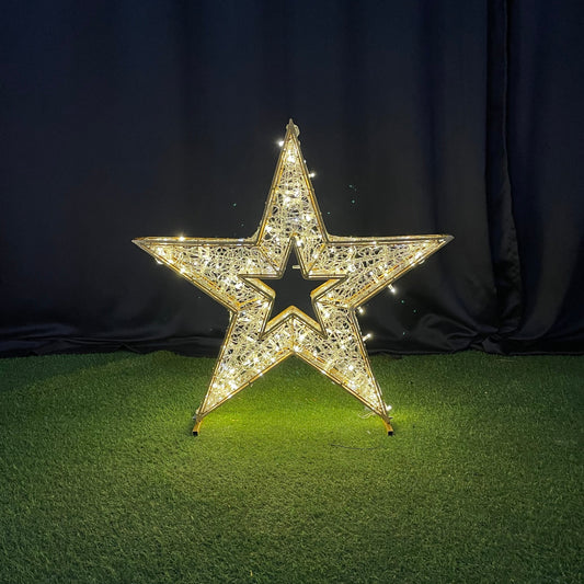 Decorative star with rhinestones on a black and green textured surface