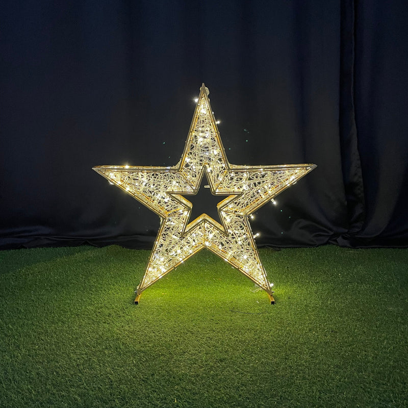 Decorative star with rhinestones on a black and green textured surface
