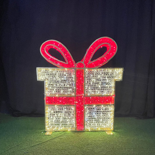 Decorative lighted gift box with a red bow on a dark background